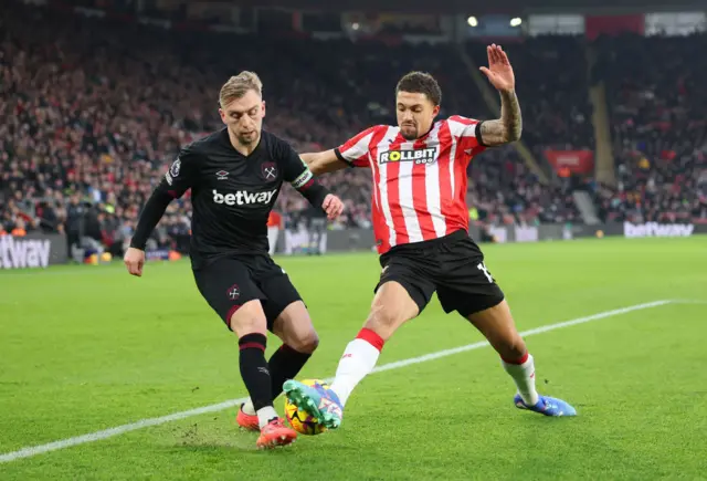 Jarrod Bowen of West Ham United is challenged by Nathan Wood of Southampton