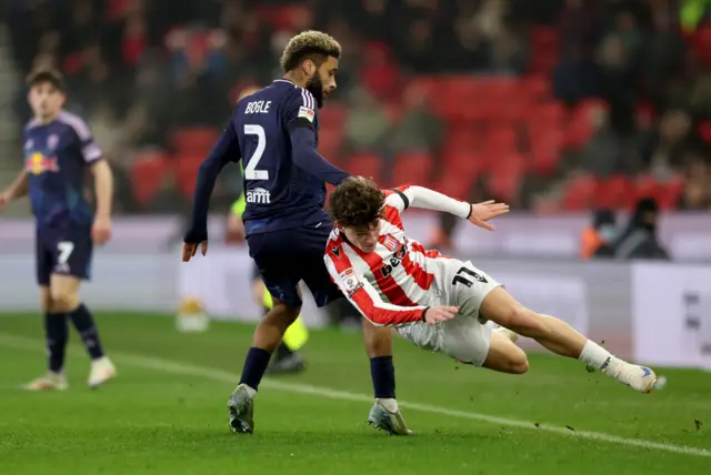 Stoke's Lewis Koumas takes on Leeds' Jayden Bogle