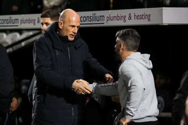 Managers shake hands