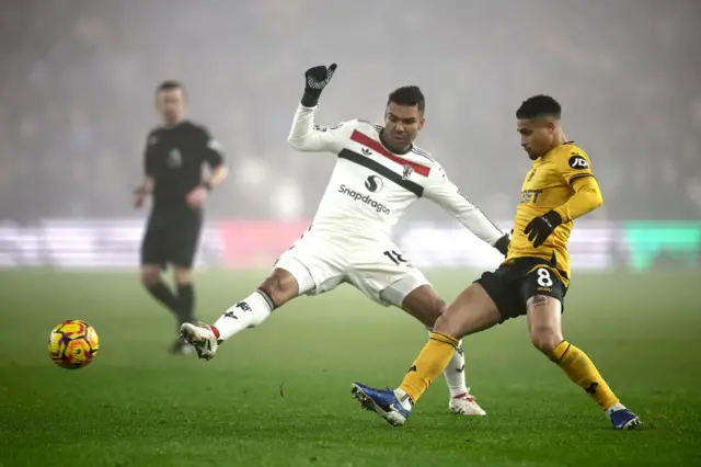 Joao Gomes fights for the ball with Manchester United's Casemiro