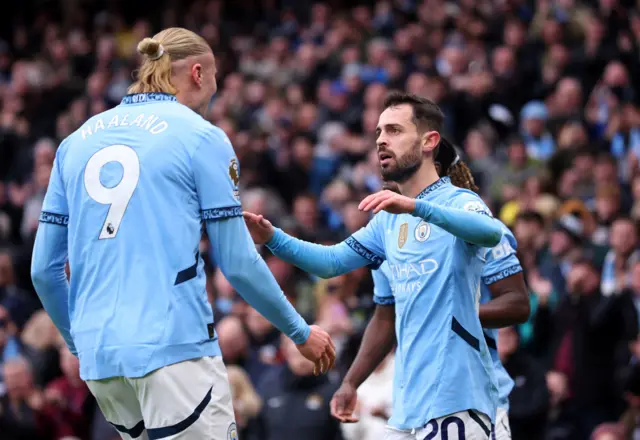 Bernardo Silva and Erling Haaland celebrate