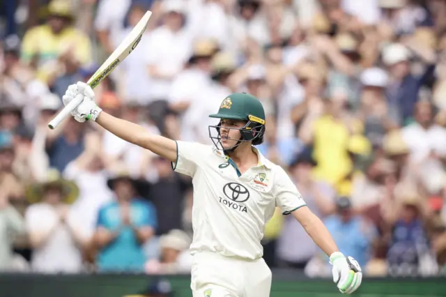 Sam Konstas raising his bat after hitting a half-century