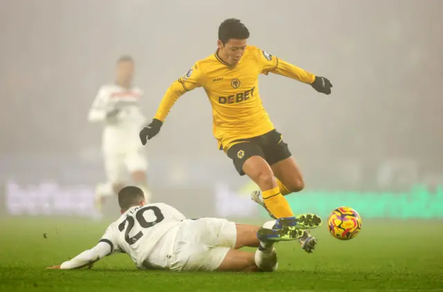 Hwang Hee-Chan of Wolverhampton Wanderers is challenged by Diogo Dalot of Manchester United