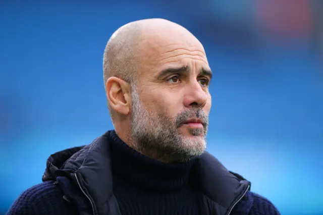 Pep Guardiola, manager of Manchester City, looks on