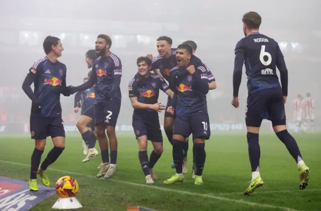 Leeds players celebrate at Stoke