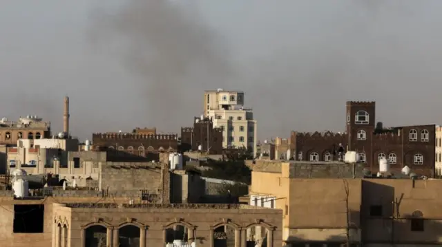 Smoke rises over buildings