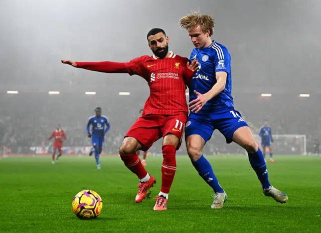 Mohamed Salah of Liverpool is challenged by Victor Kristiansen