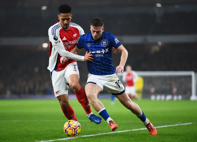 Liam Delap of Ipswich Town is challenged by William Saliba