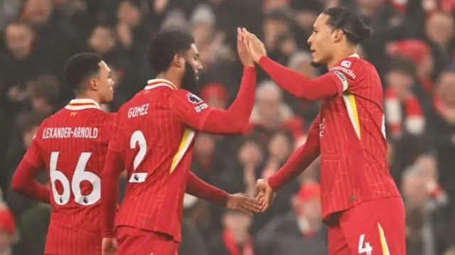 Liverpool's Joe Gomez high-fives Virgil van Dijk