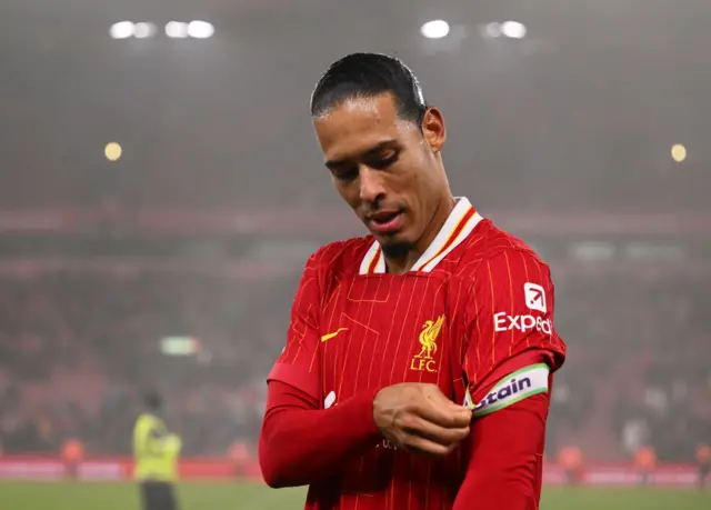 Virgil van Dijk putting his captain armband on