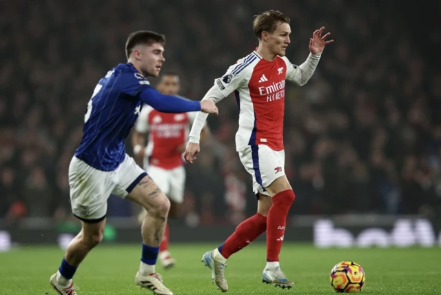 Ipswich's Leif Davis (L) in action with Arsenal's Martin Odegaard