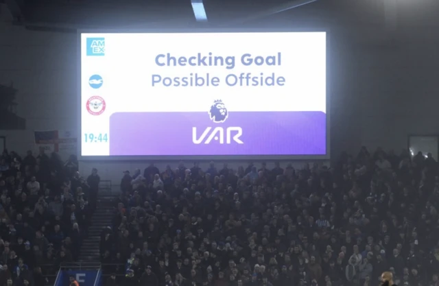 The big screen displays a VAR review message