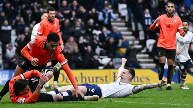 Emil Riis celebrates while lying on the turf after putting Preston 3-1 up against Sheffield Wednesday