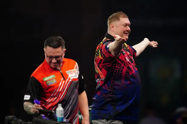 Ricky Evans in action during his third round match against Robert Owen (left) on day twelve of the Paddy Power World Darts Championship at Alexandra Palace, London