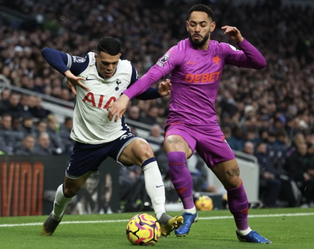 Tottenham Hotspur's Pedro Porro in action with Wolverhampton Wanderers' Matheus Cunha