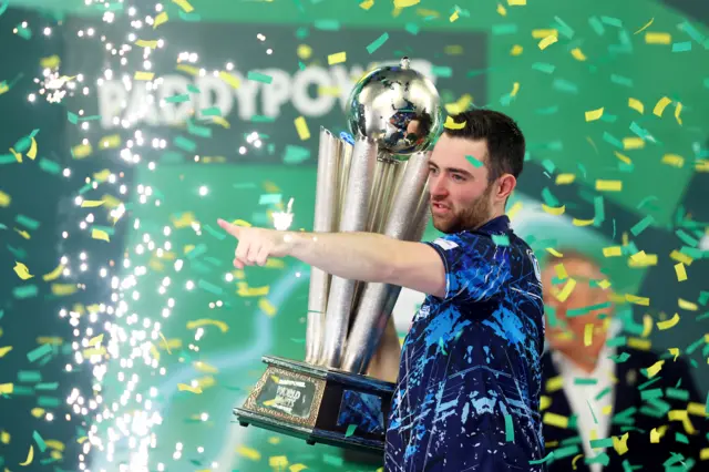 Luke Humphries celebrates winning the 2024 PDC World Darts Championship