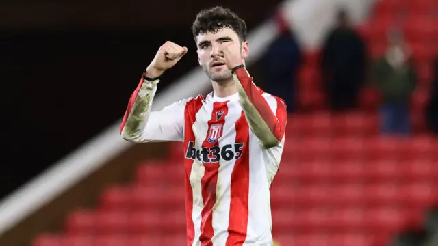 Stoke City goalscorer Tom Cannon raises both hands in celebration