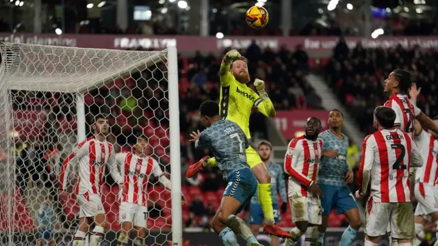 Stoke goalkeeper Viktor Johansson punches clear