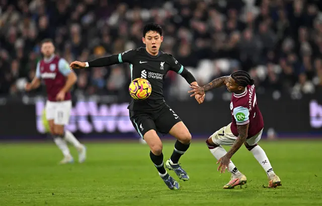 Wataru Endo of Liverpool controls the ball