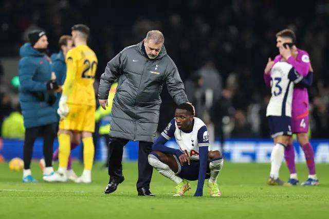 Tottenham Hotspur manager Ange Postecoglou pats a dejected Pape Matar Sarr