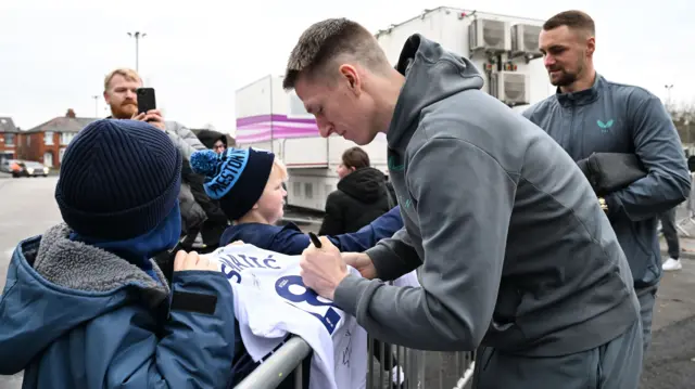 Preston North End striker Emil Riis Jakobnsen signs autographs for fans outside Deepdale