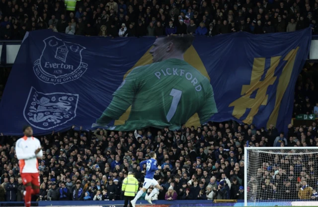 Everton fans display a banner featuring Jordan Pickford in the stand