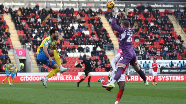 Kyle Wootton of Stockport County lobs Dillion Phillips of Rotherham but fails to score