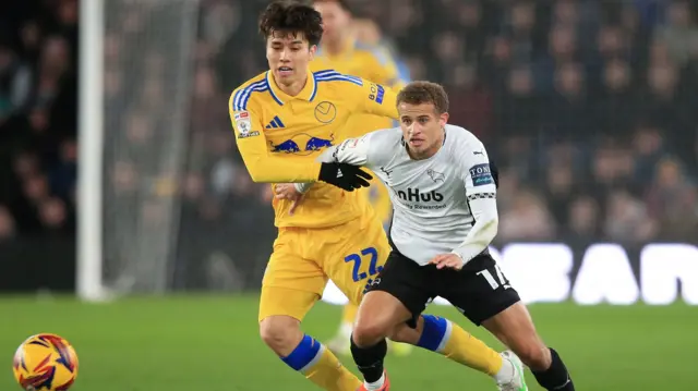 Leeds midfielder Ao Tanaka battles with Derby's Kenzo Goudmijn