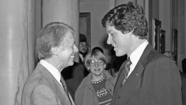 Black and White photo of Carter and Clinton shaking hands