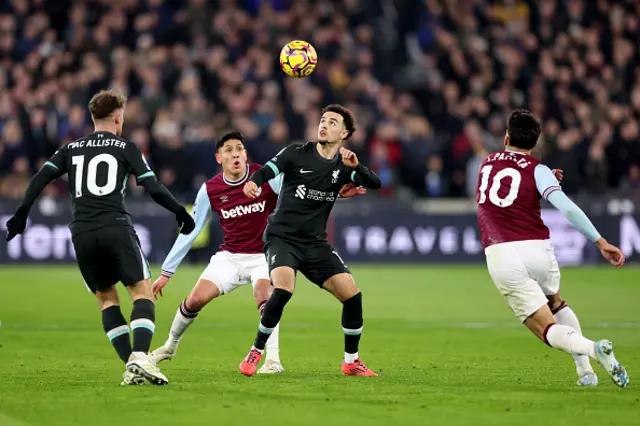 Curtis Jones of Liverpool is challenged by Edson Alvarez