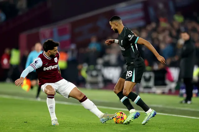 Cody Gakpo of Liverpool is challenged by Lucas Paqueta