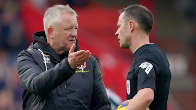 Sheffield United manager Chris Wilder speaks with referee Stuart Attwell at full-time