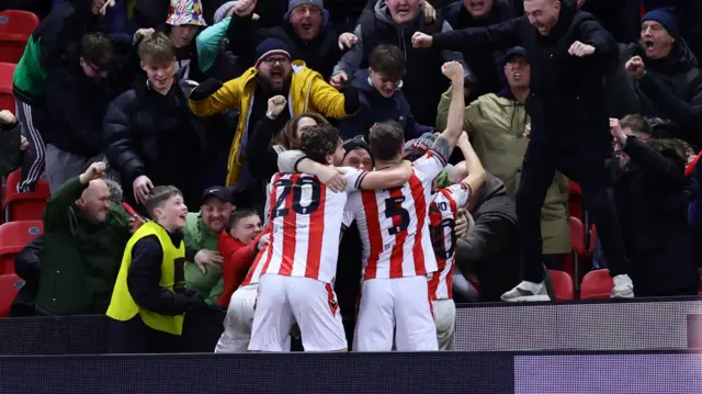 Stoke players celebrate with fans after Tom Cannon's goal