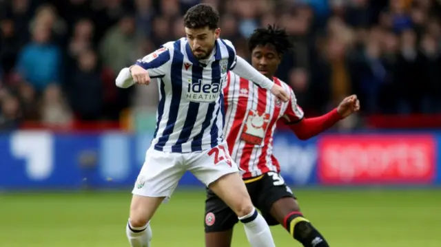 West Brom's Mikey Johnstone holds off the challenge of Sheffield United's Andre Brooks