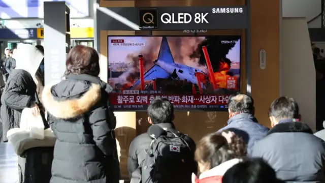 People watch the news on a TV