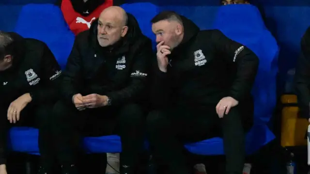 Wayne Rooney in discussion with assistant Mike Phelan in the dugout