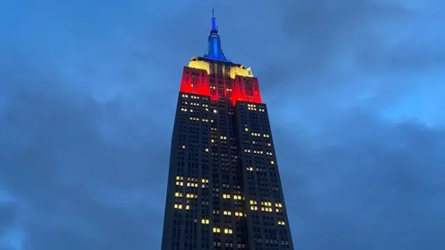 Picture shows the building lit up in red white and blue