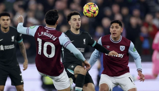 Liverpool's Curtis Jones in action with West Ham United's Lucas Paqueta and Edson Alvarez