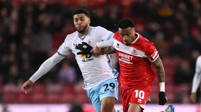 Middlesbrough's Delano Burgzorg runs with the ball under pressure from Burnley's Josh Laurent