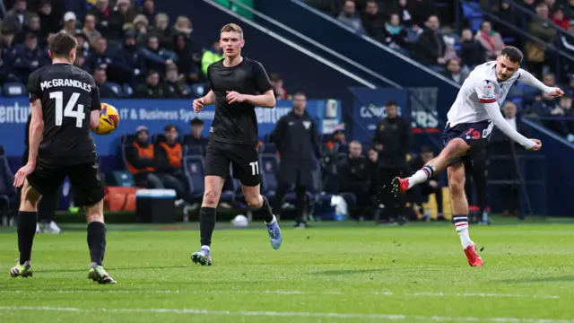 Aaron Collins of Bolton Wanderers scores to make it 1-0 against Lincoln City