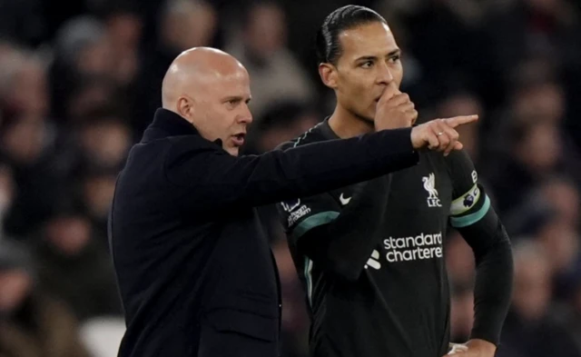 Liverpool manager Arne Slot (left) speaks with Virgil van Dijk