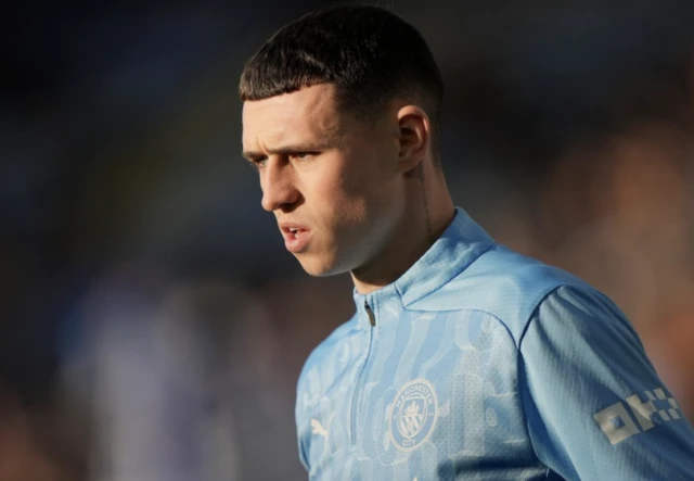 Manchester City's Phil Foden warms up