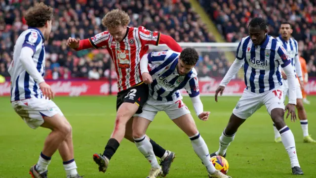 Sheffield United's Tom Davies battles for possession against West Brom