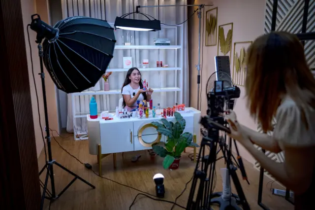 A live host promotes products for a skincare brand on a TikTok Shop livestream at one of the studios of Ownline Marketing on June 26, 2024 in Pulilan, Bulacan province, Philippines.