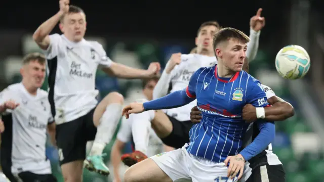 Linfield and Glentoran players battle for the ball