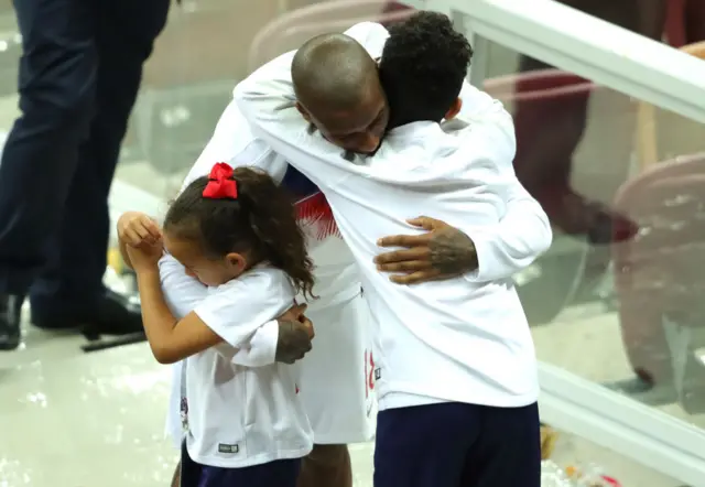 Ashely Young hugs his family