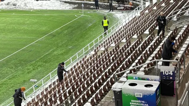 Staff at the Bolt Arena sweeping away the snow