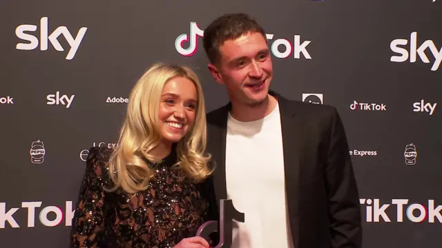 Ryan Losasso and Jade Beaty hold their award