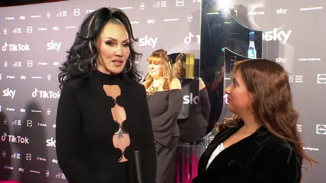 Michelle Visage speaking on a red carpet