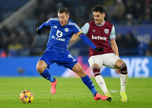 Jamie Vardy of Leicester City runs with the ball under pressure from Konstantinos Mavropanos of West Ham United